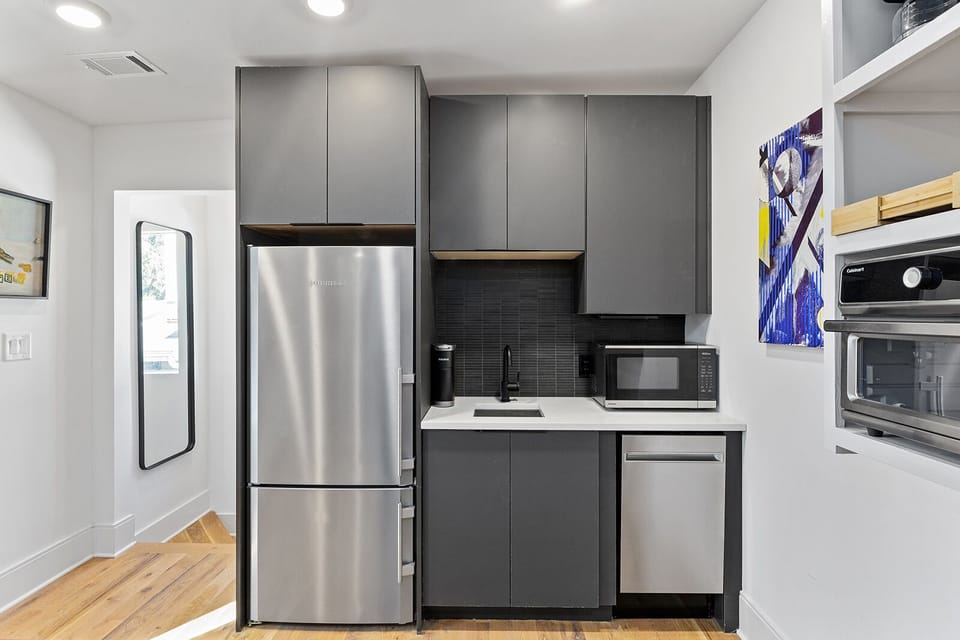 Kitchen refrigerator, microwave, sink and toaster oven (on right-hand side)