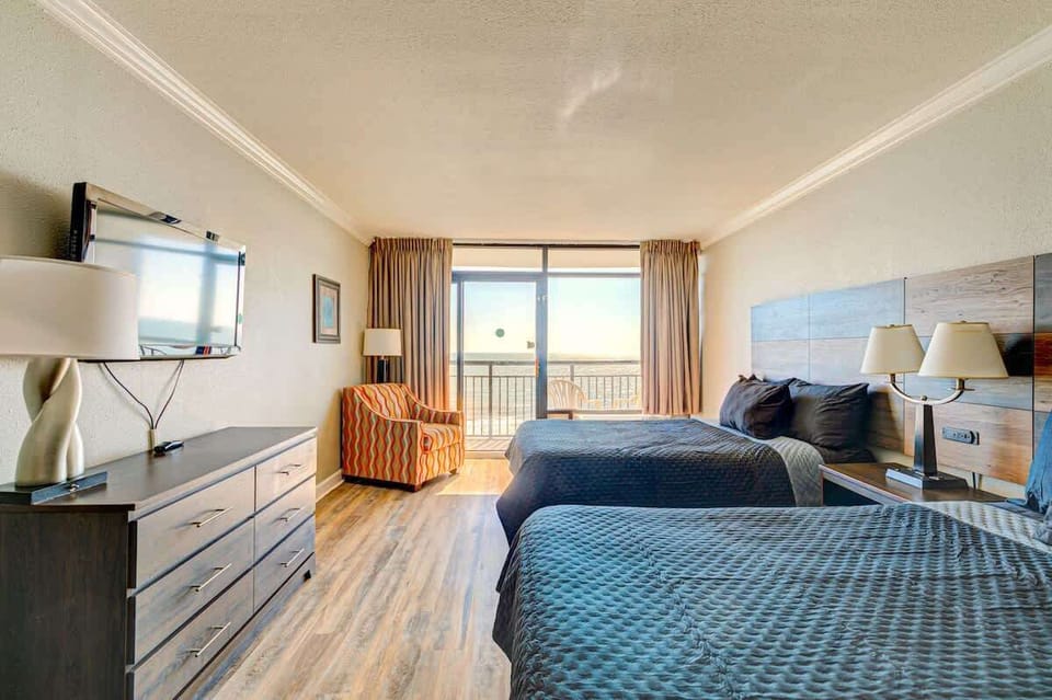 Cozy beachfront comfort with a view—drift off to the sound of the waves in your dreamy Myrtle Beach room.