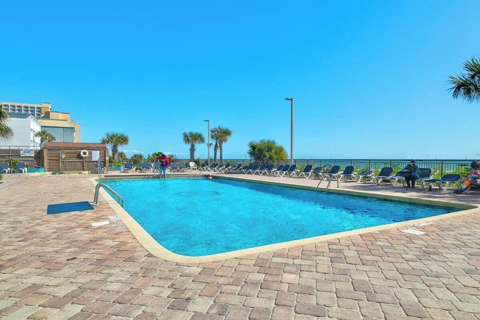 Family fun in the sun-drenched pool, a refreshing oasis with a view of the Myrtle Beach skyline.