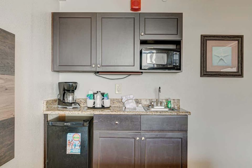 Convenience at your fingertips with this well-equipped kitchenette—perfect for morning coffee or quick bites.