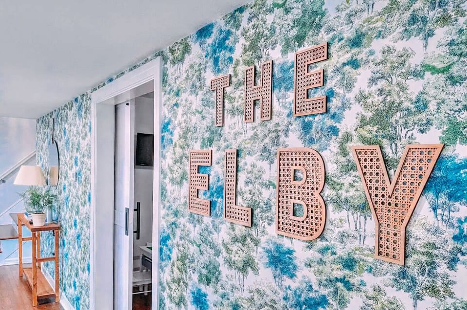 The foyer w/ Cypress themed wallpaper and our signature scent aroma dispenser