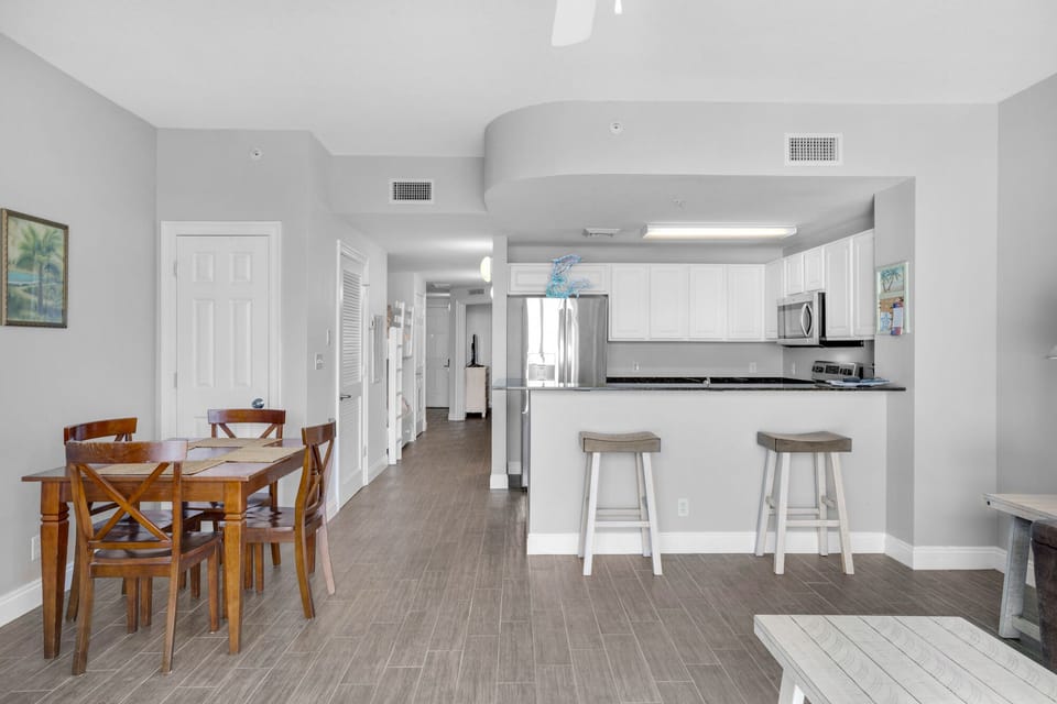 Dining Area - Gather in this stylish dining area with seating for four, perfect for savoring home-cooked meals while soaking in the stunning beach views! Includes 2 bar stools at the kitchen bar for extra seating.