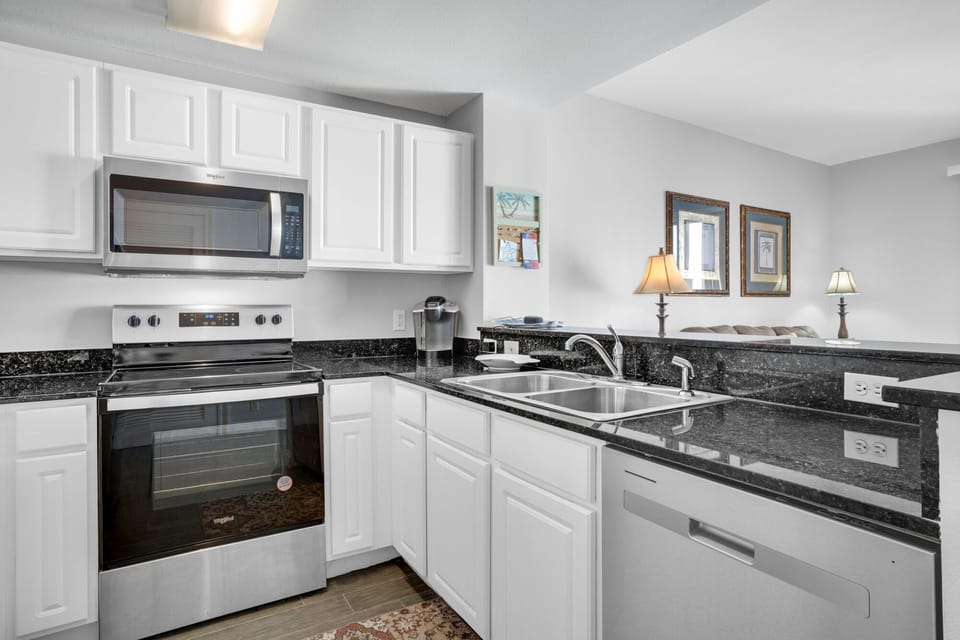 Kitchen - Elevate your stay with this fully equipped gourmet kitchen, featuring sleek appliances, gorgeous counters, and all you need to create culinary masterpieces.