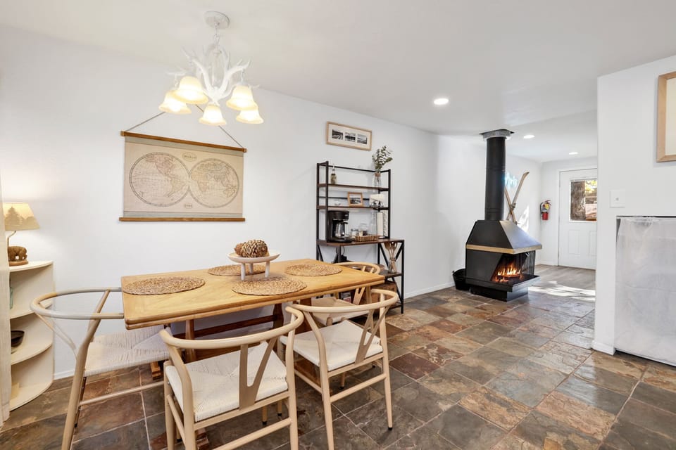 Gather for meals and memories in this inviting dining space with a beautiful fireplace nearby, perfect for family dinners, family fun, board games, or romantic dinners.