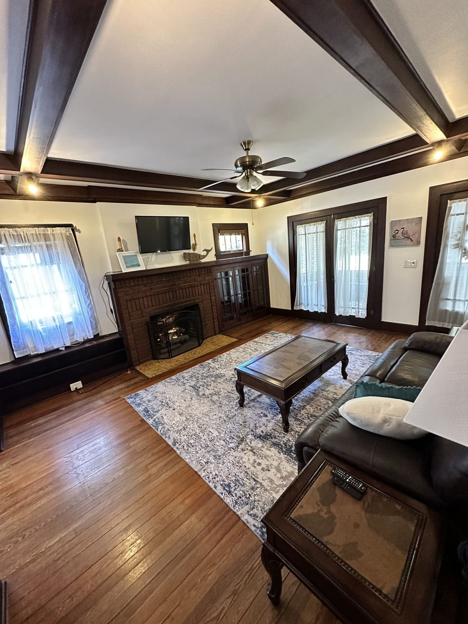 Living area with gas fireplace and original built ins
