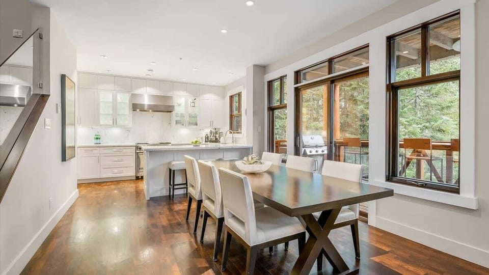 - Bright dining area with warm wood floors and views  
- Seamless flow to kitchen and balcony with mountain air  
- Perfect Whistler rental for gatherings and ski retreats  
