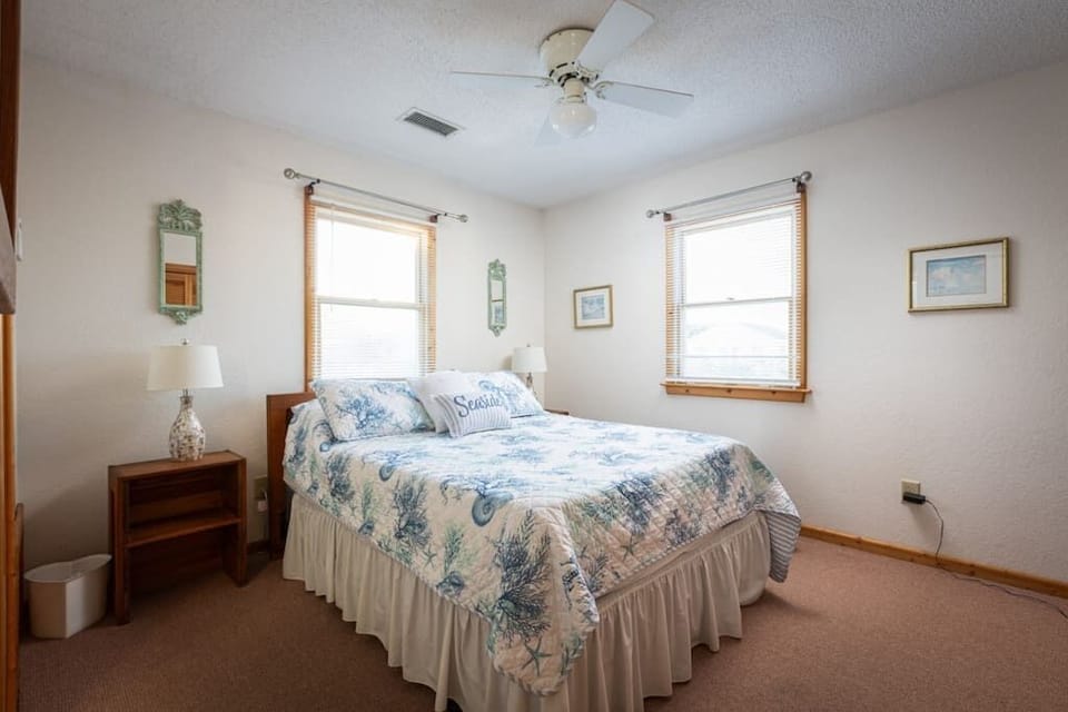 Top Level Queen Bedroom with Ensuite Full Bath, TV, Ceiling Fan, and Natural Light from Multiple Windows