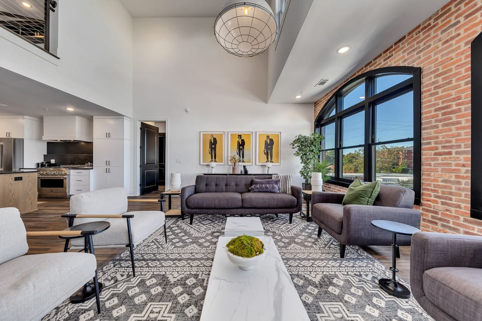 Stylish seating & art create a cozy spot to unwind in this light-filled great room