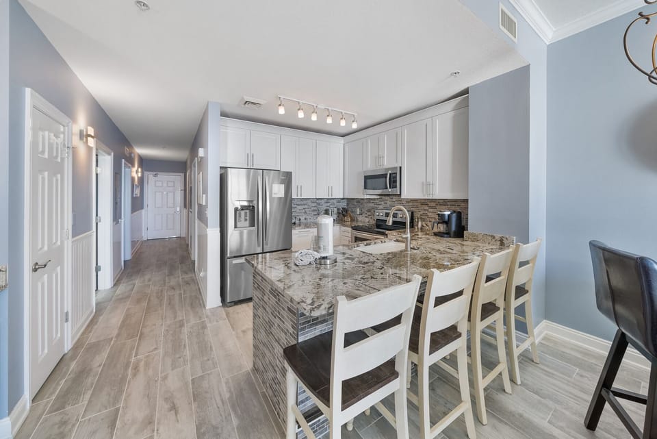 Your spacious kitchen features granite countertops, stainless steel appliances, and a breakfast bar where you'll enjoy morning coffee.