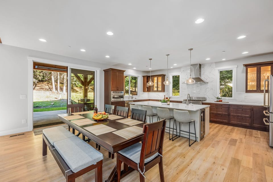 Chef's kitchen — Thermador range, island seating for 4 and patio access