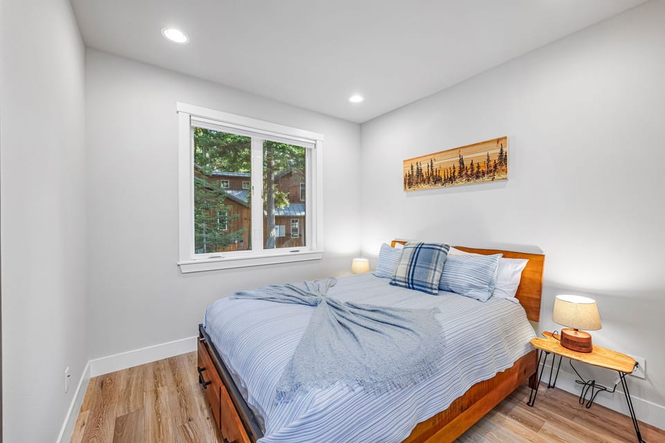 Bedroom 2 — queen bed on the main floor with adjacent powder room