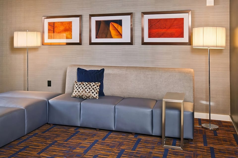 Sink into plush seating beneath warm lighting and modern art.