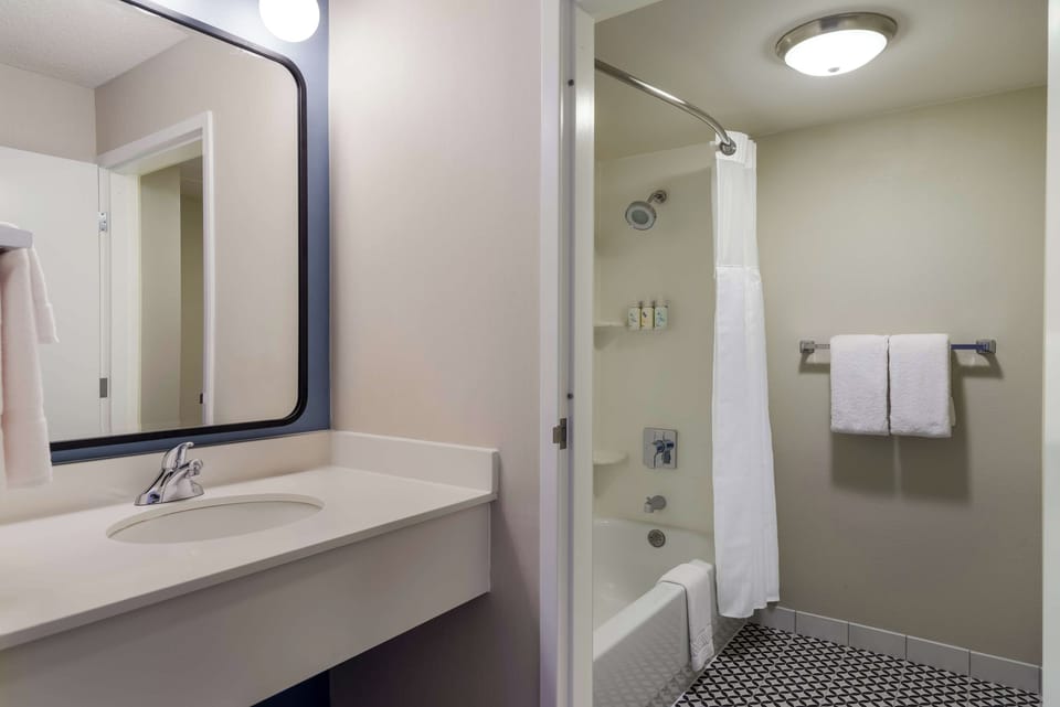 Refresh in a clean bath with bright vanity lighting.