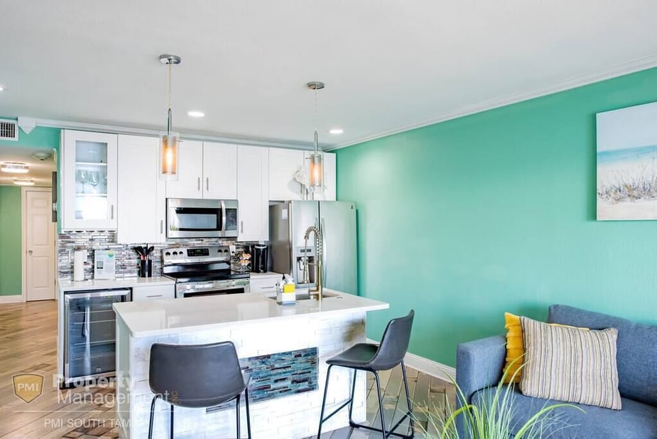 Plenty of space to prep and serve on the generous island with a built-in sink and dishwasher with easy access to stainless stove appliances. Chill a glass of wine in your wine fridge, or brew a cup of coffee, before enjoying the view on your balcony.