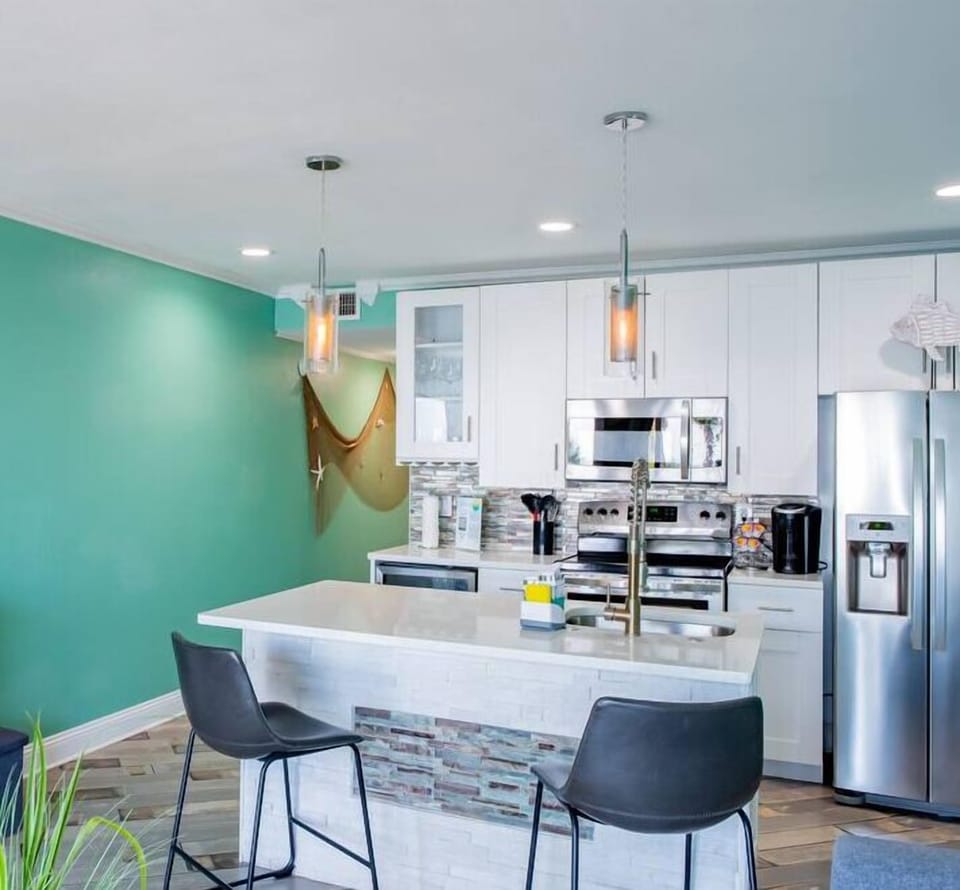 Updated kitchen and open-concept living and entertainment area connect through a short hallway to the master bedroom and full bath.