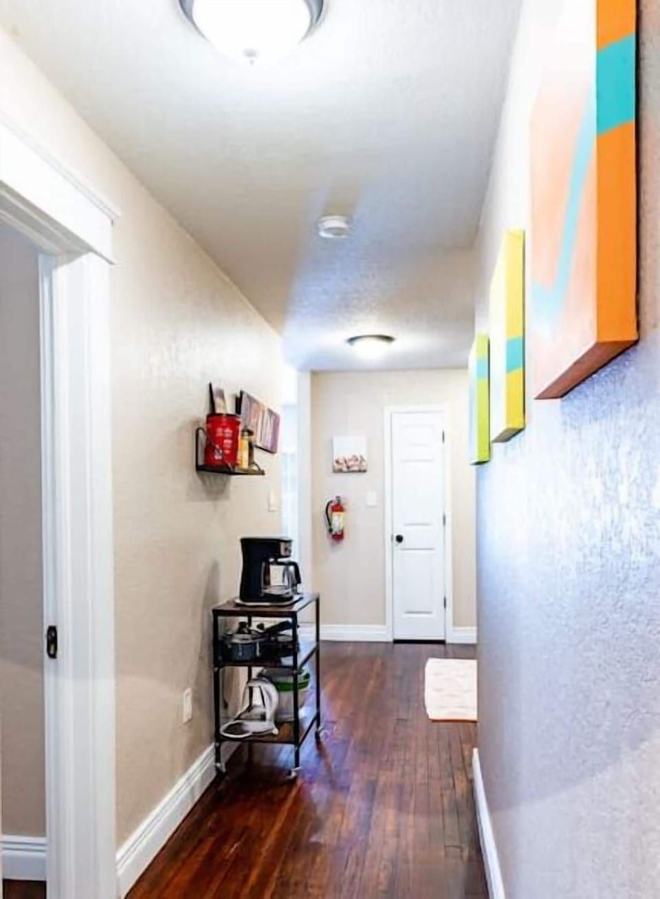 The kitchen is conveniently located down this short corridor.
