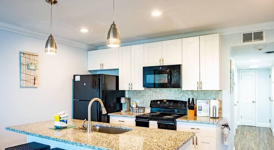 The full eat-in kitchen sits four comfortably. Includes everything you need: refrigerator, oven, microwave, dishwasher, coffee maker, flatware, and cookware.