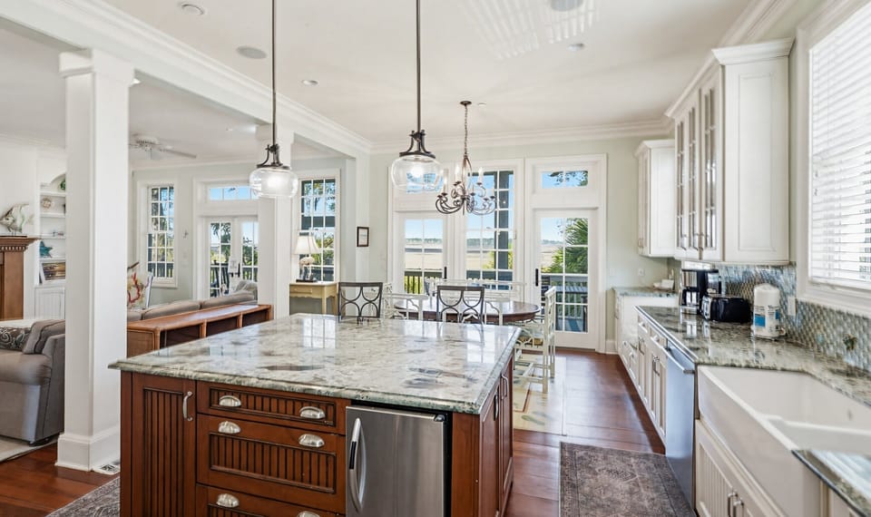 Kitchen with Island Bar,  Dining Area and Access to Back Screened Porch
