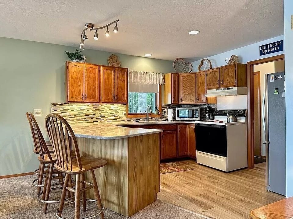 Open concept kitchen with counter height barstools