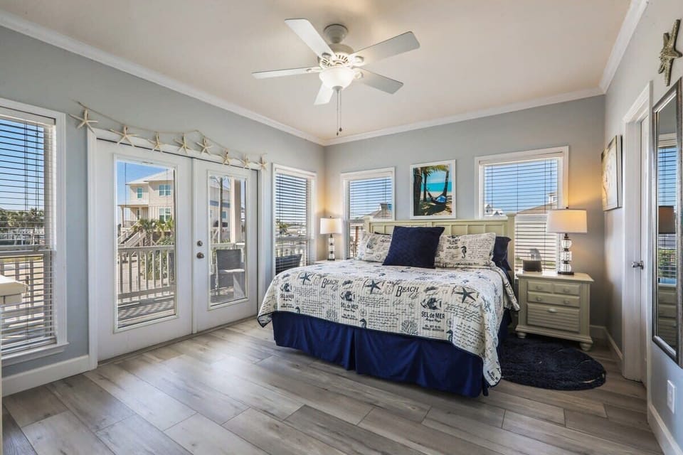 Spacious master bedroom with new king mattress,  balcony access, and a private bath. 