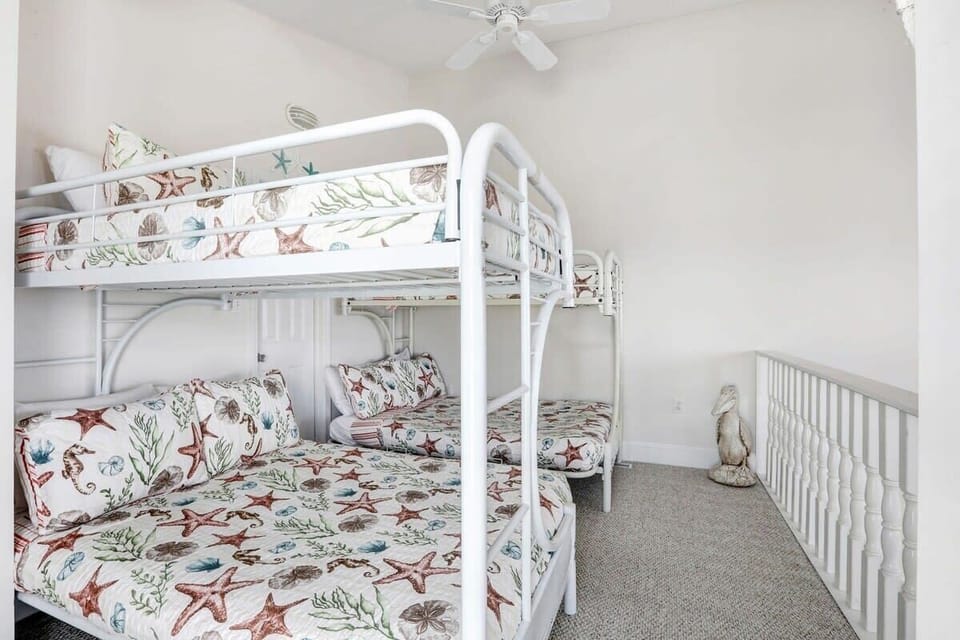 Landing area on upper level with 2 Captains beds (twin mattress over full).  