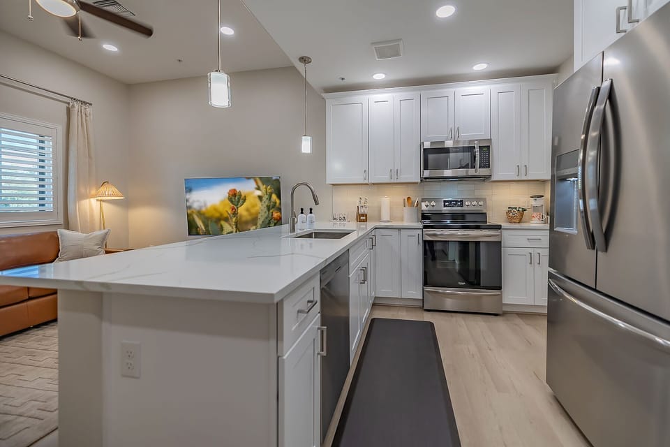 Spacious, fully equipped kitchen featuring modern appliances, ample counter space, and all the essentials you need for cooking delicious meals during your stay. Perfect for culinary adventures!
