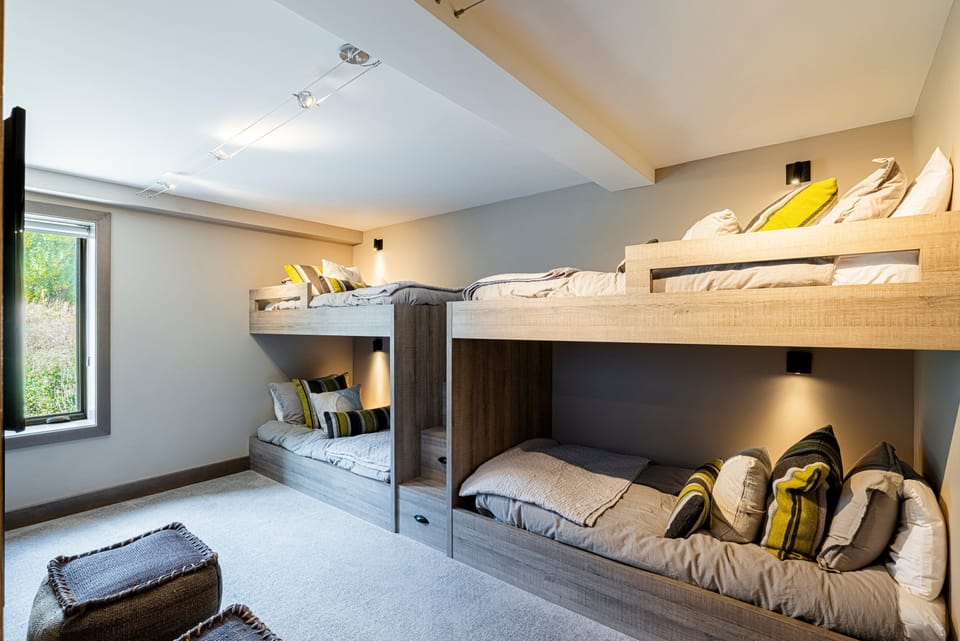Unit F - Main level Bedroom 5 - Two custom built-in twin over twin bunk beds and 50" Smart TV