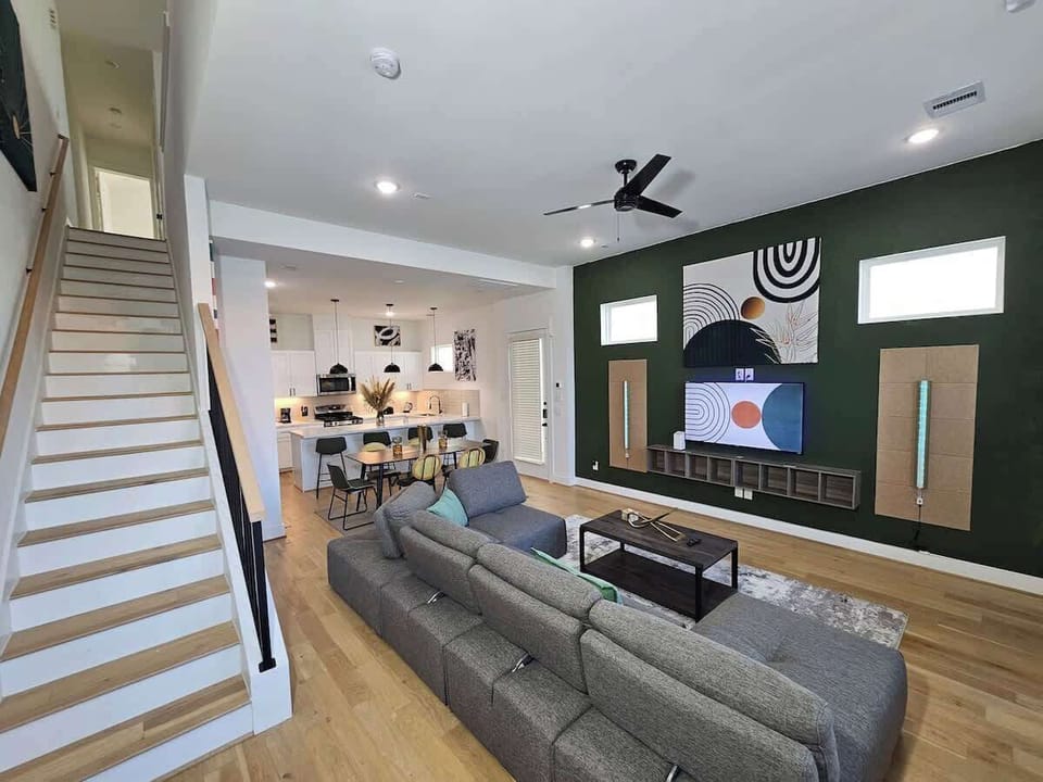 "Elegance in Mind: Our Mid-Century Modern living room, where a green accent wall meets a 55" TV and LED sconces for a touch of luxury."  Welcome Home!