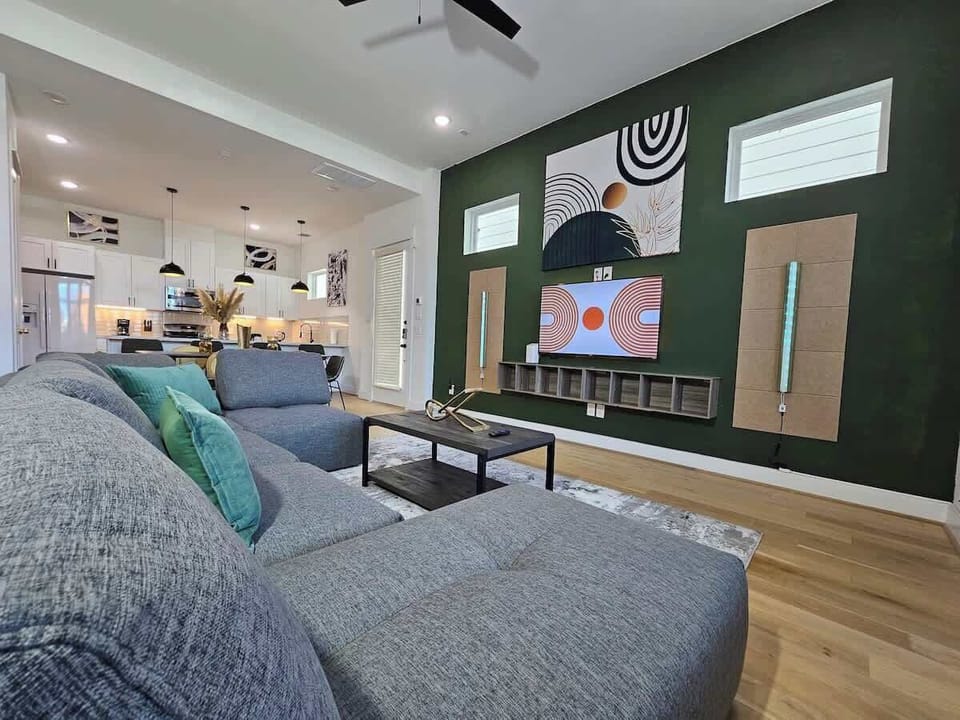 "Modern living at its finest! Our open-concept Mid-Century space is bathed in natural light, featuring hardwood floors and a 55" TV."