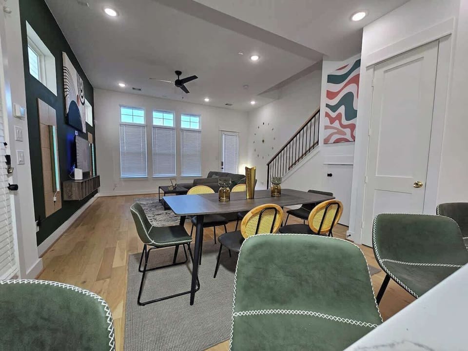 "Live in style in our Mid-Century Modern sanctuary with green highlights. Marble counters, hardwood floors, and elegant black and gold accents make every day feel luxurious."