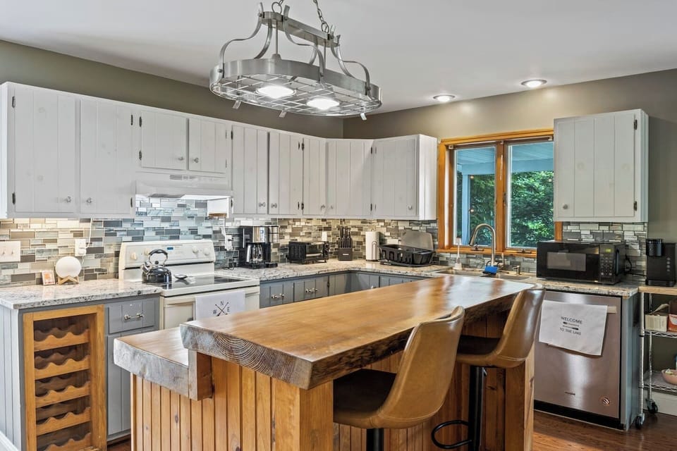 Prepare meals in this well-equipped kitchen with modern appliances, a large island, and stylish countertops.