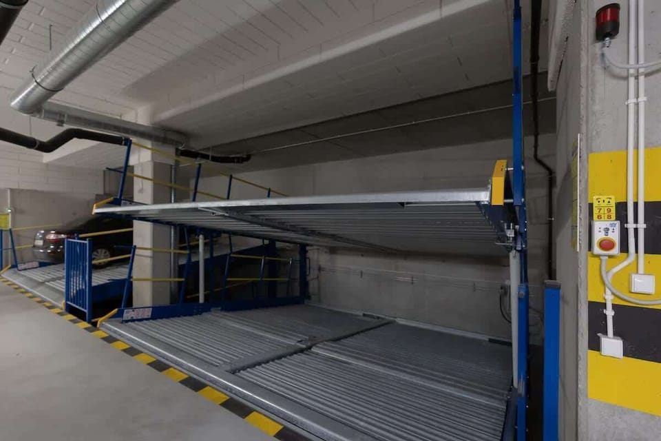 An underground parking garage with designated spaces and clear signage.
