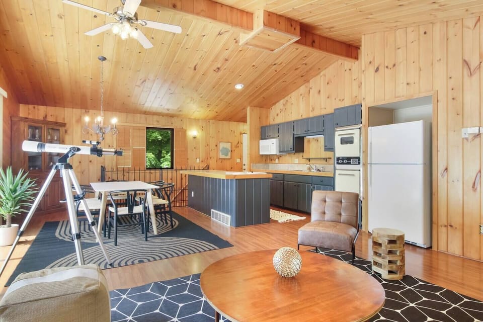 Open dining and kitchen space with vaulted wood ceilings