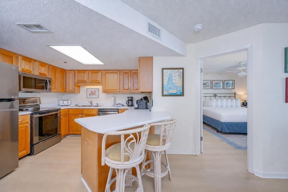 Warm light fills the kitchen as you prepare snacks before retreating to the king master suite for rest