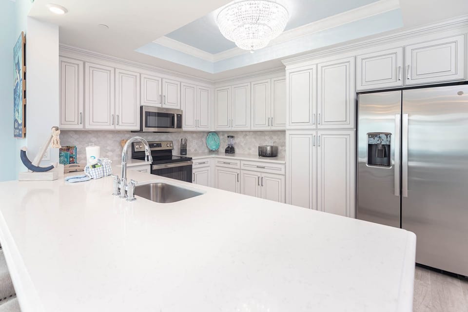 Prepare meals in this kitchen with elegant cabinetry, stainless appliances, and spacious countertops