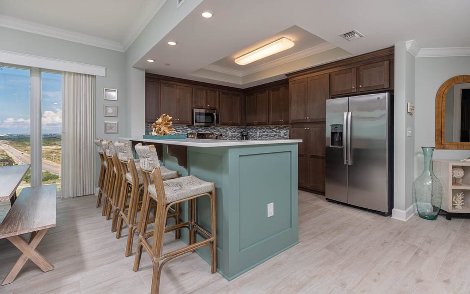 Savor your morning coffee and watch the beach through the windows in this stylish kitchen area