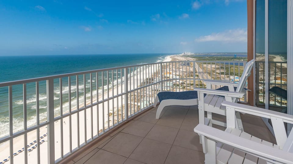 Experience seemingly endless coastline views of the horizon from your corner balcony as waves lap the shore