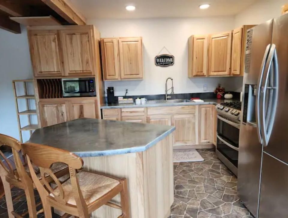 Fully-equipped kitchen includes a gas stove, double oven, ice maker, Keurig.