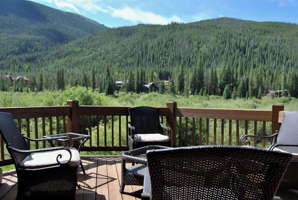 Relax on your private deck with comfortable seating while taking in the stunning forested mountain landscape that surrounds this peaceful retreat.
