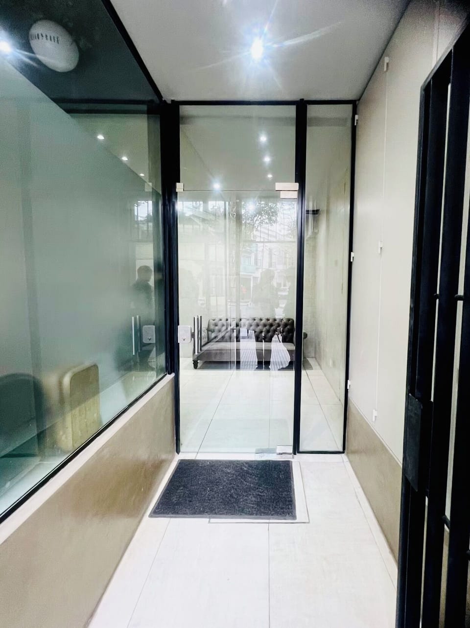 Main entrance from the street. Double doors (gate and glass door)