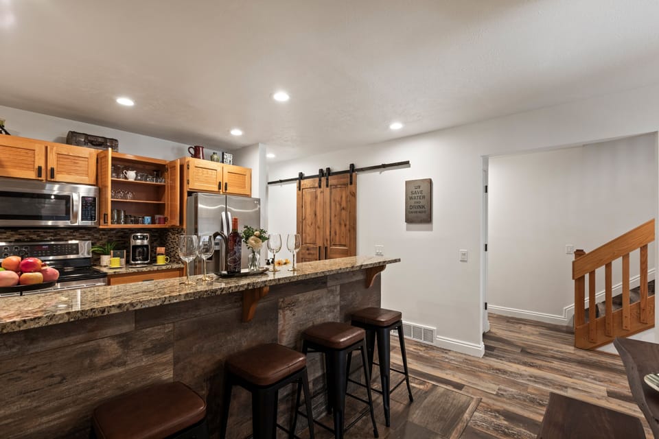 Granite counters and a pantry behind the barn door