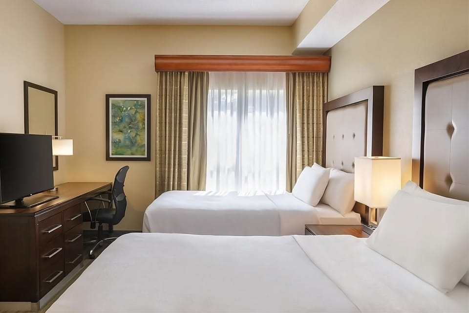 Drift off easily in a bright room with two beds.