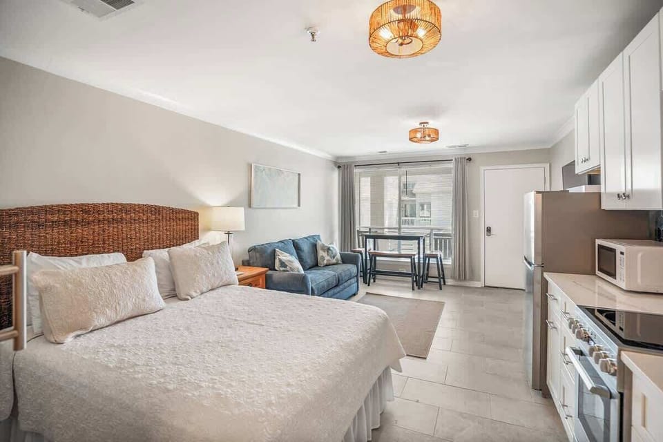 Living Room with Queen Sleeper Sofa, Queen Bed, Dining Table and Kitchen