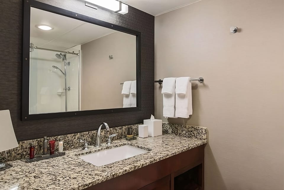 Get ready with a spacious granite vanity and bright mirror.