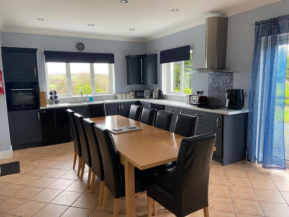 Ballygarrett Holiday Home, County Wexford. Open plan dining area with large table. Modern bright kitchen.