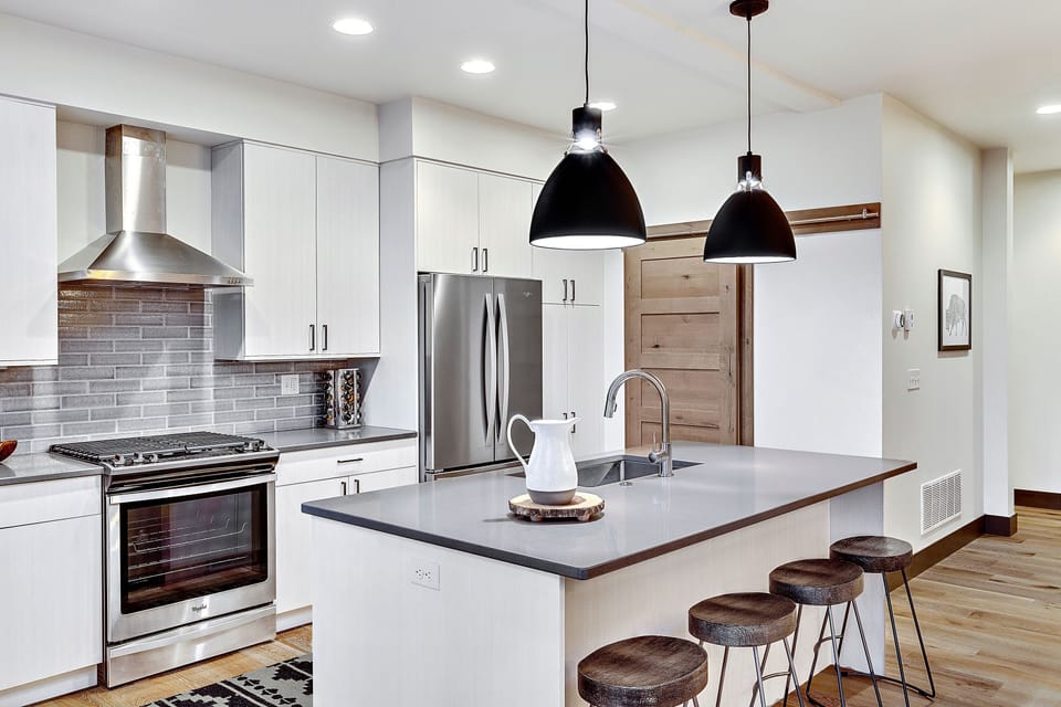 Open plan kitchen with modern appliances and breakfast bar